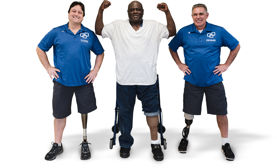  Todd and Dennis standing with an amputee rehabilitation patient. Patient is standing in a victory pose with his hands above his head.